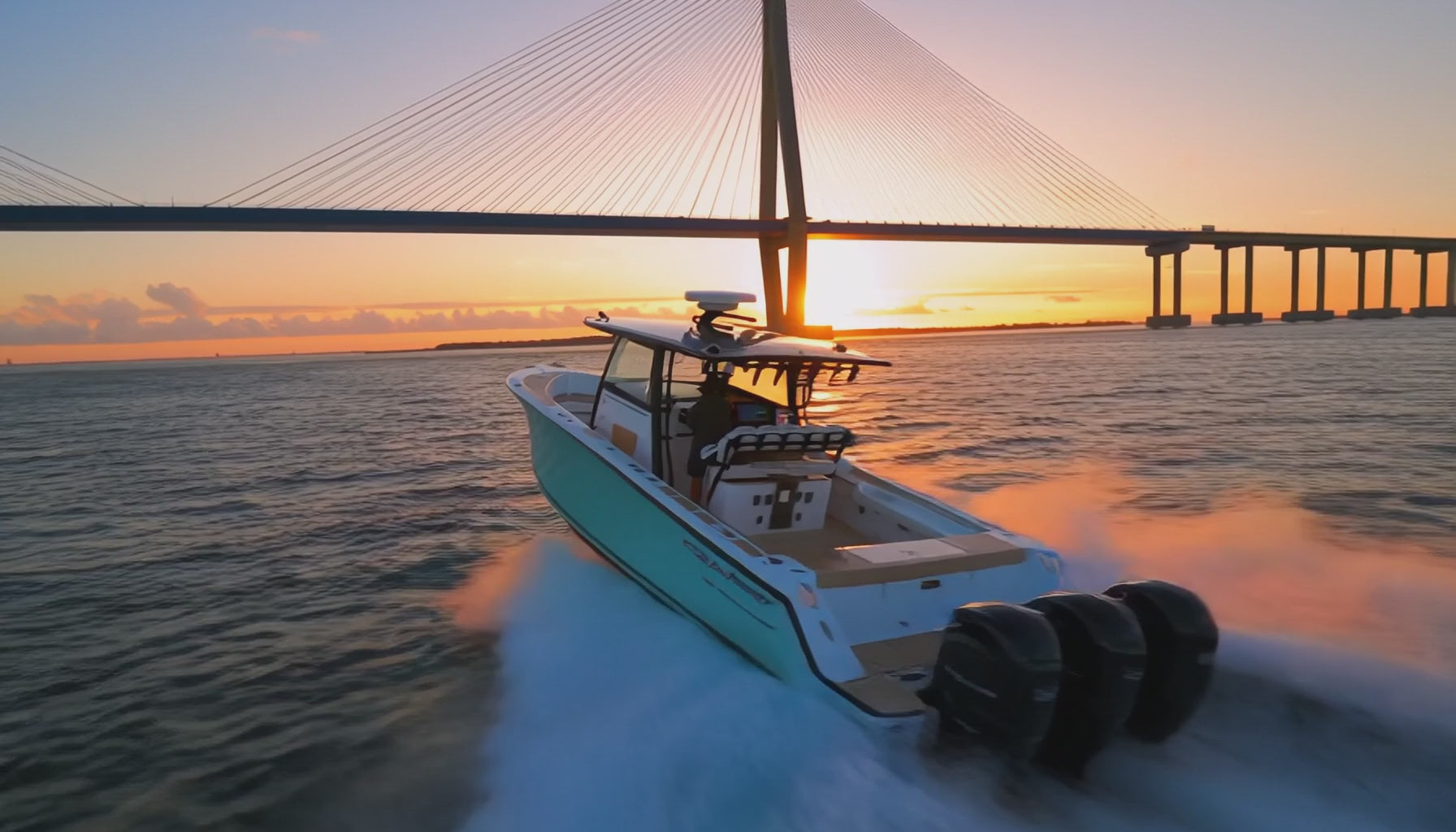 Load video: Cinematic 4K hero video of a luxury yacht glass bridge featuring triple Simrad MFD touchscreens, integrated sonar, and open-array radar cruising at sunset.
